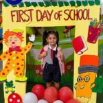 Pre-primary student smiling at The Ken World School Jaipur welcome back to school decoration after summer vacation.